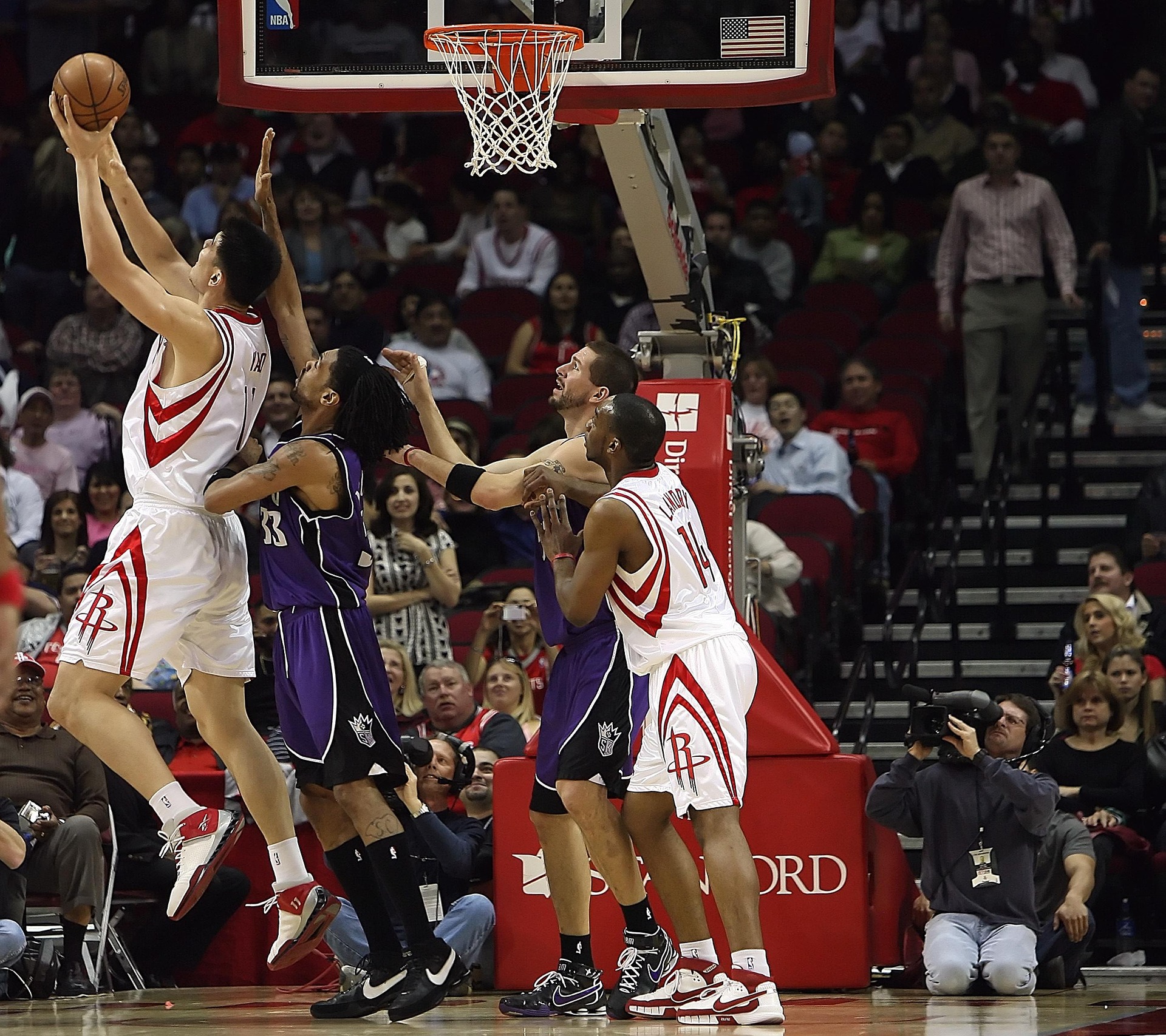 Raptors and Lakers players competing during an NBA match