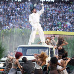 Bad Bunny holding a Grammy Award on stage
